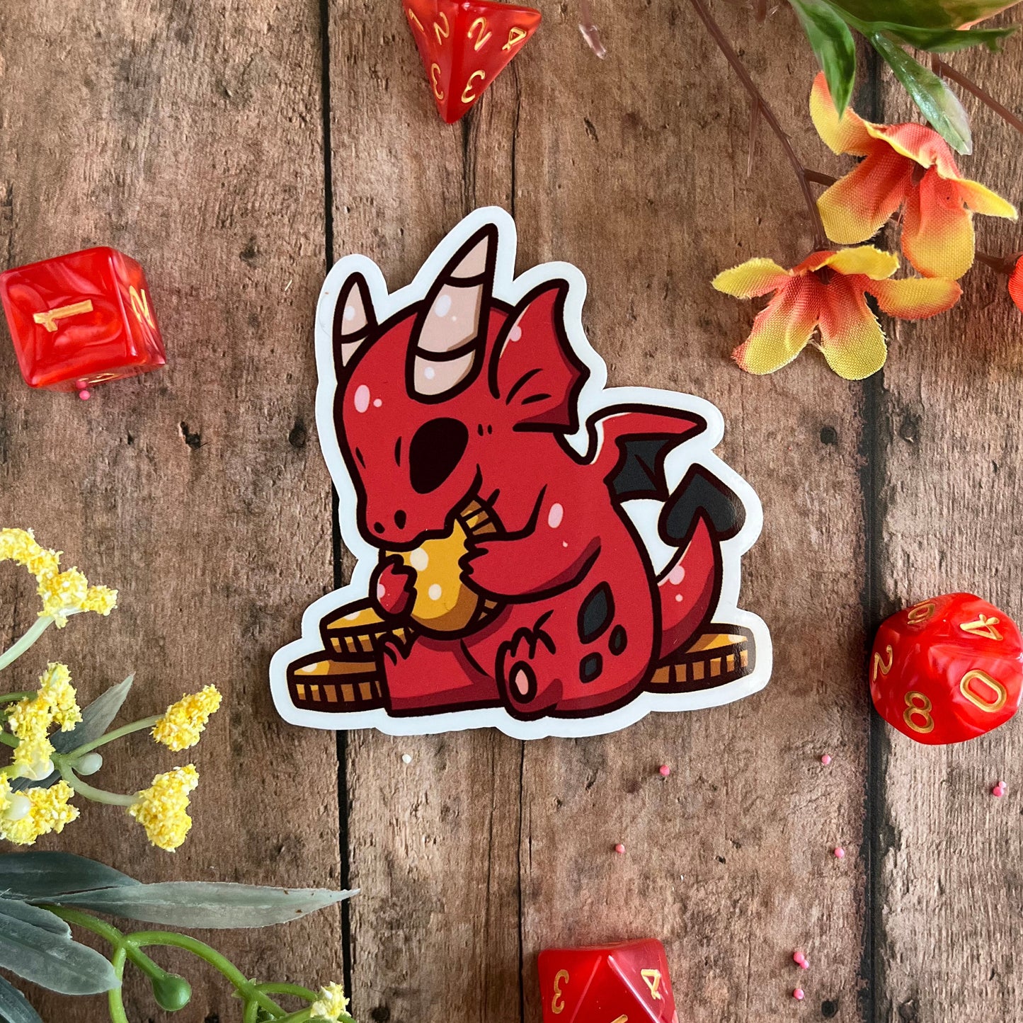 The main photo of the sticker is accented with dice and flowers.